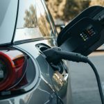 Close-up of an electric vehicle being charged, highlighting modern clean energy technology.